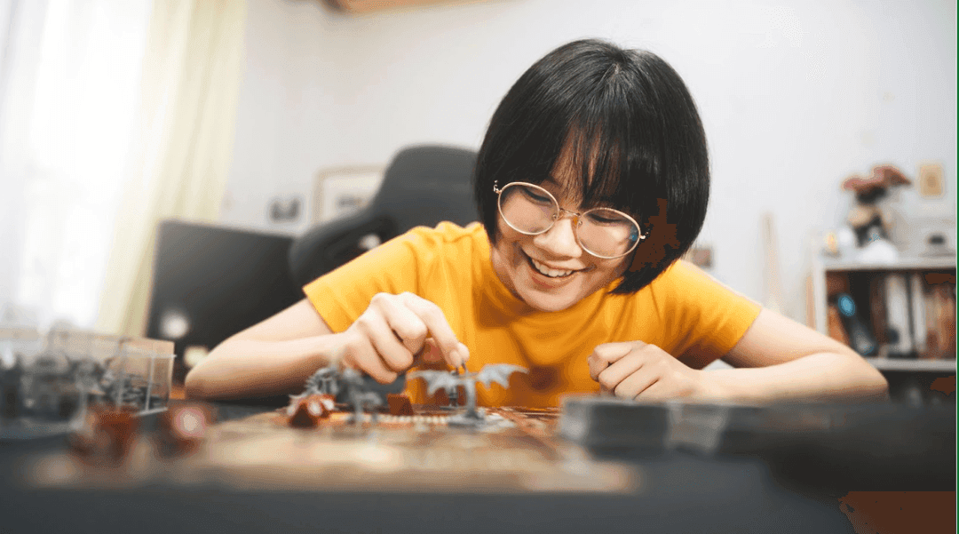 Woman sitting at a table playing D&D